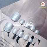 Elegant Pearlized White Press-On Toe Nails with Marble Effect